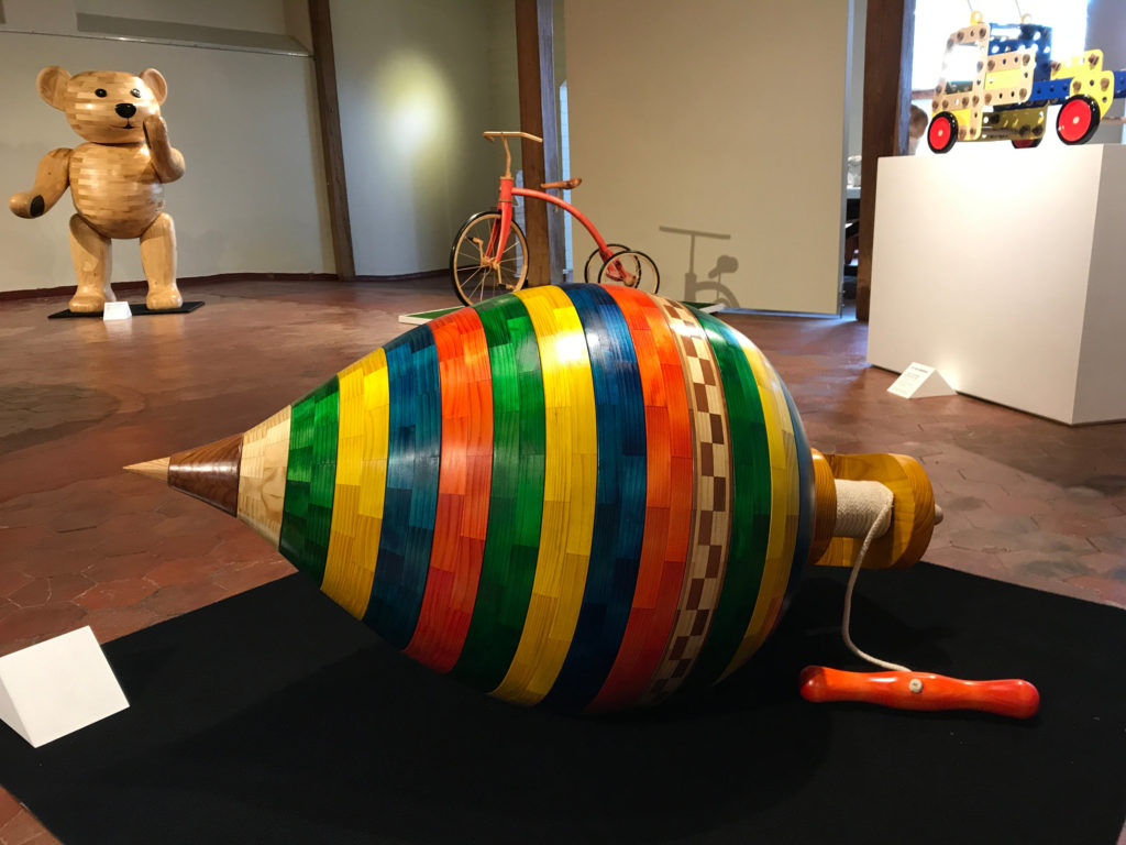 Spinning top, brothers red trike, wood teddy & meccano set truck sculptures by John Abery